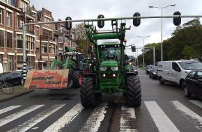 Twee tractoren rijden over de Koningskade in Den Haag.